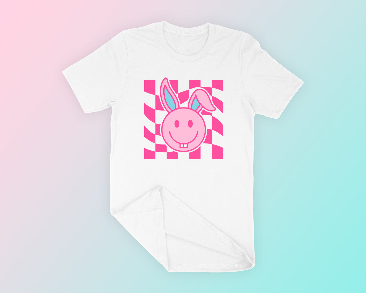 My Checkered Happy Face Easter Bunny SVG is part of my Easter SVG files for Cricut collection, and features a t-shirt mockup of a trendy happy face-style Easter bunny with goofy teeth and floppy ears on a checkered background.